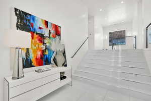 Stairs featuring recessed lighting and tile patterned flooring