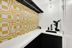 Kitchen with dark cabinetry and modern cabinets