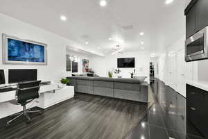 Living area featuring an office area, recessed lighting, and dark wood-style floors