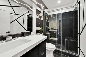 Full bathroom with vanity and a stall shower