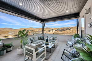 View of patio / terrace with a residential view, a mountain view, and an outdoor living space