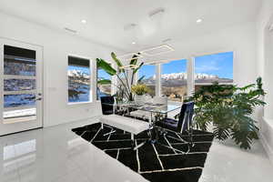 Tiled dining area featuring a mountain view and recessed lighting