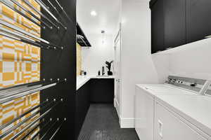 Laundry area featuring cabinet space, dark tile patterned flooring, independent washer and dryer, and recessed lighting