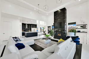 Living area with a high ceiling, recessed lighting, and a fireplace