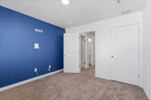 Bedroom featuring carpet floors and baseboards