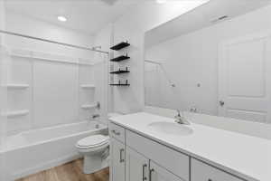 Full bathroom with vanity, light wood-type flooring, and bathtub / shower combination