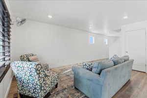 Living area featuring wood finished floors and recessed lighting