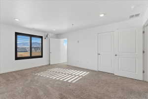 Bedroom featuring baseboards and carpet
