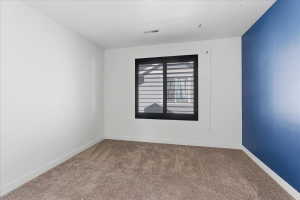 Carpeted bedroom with baseboards