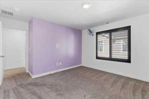 Carpeted bedroom with baseboards