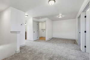 Unfurnished bedroom featuring light colored carpet and baseboards