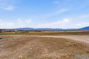 View of mountain backdrop featuring rural landscape