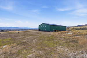 View of pole building featuring a mountain view and a rural view