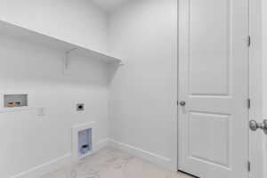 Laundry area with light marble finish flooring, washer hookup, and electric dryer hookup