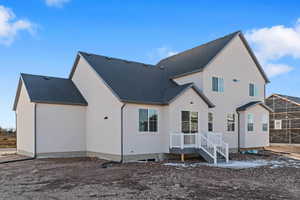 Back of property with roof with shingles, stucco siding, and a deck