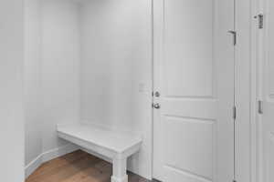 Mudroom with wood finished floors and baseboards