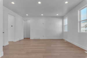 Unfurnished room with recessed lighting and light wood-type flooring