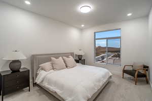 Bedroom featuring light colored carpet, recessed lighting, and a mountain view