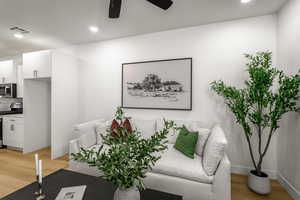 Living room with light wood-style floors, recessed lighting, and ceiling fan