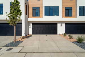 Modern home with stucco siding, driveway, and a garage