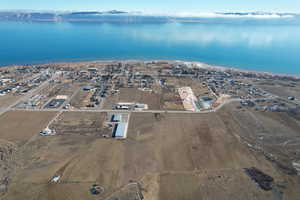 Aerial overview of property's location featuring a large body of water and nearby suburban area