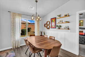 Dining area with a chandelier and wood finished floors