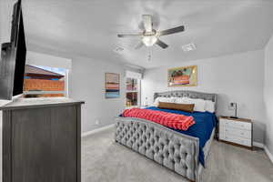 Bedroom with light carpet and ceiling fan