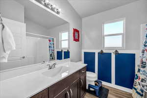 Bathroom with vanity, curtained shower, and light wood-style floors