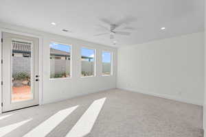 Empty room with light colored carpet, recessed lighting, and ceiling fan
