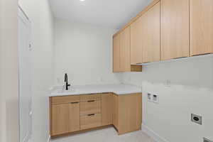 Washroom featuring washer hookup, cabinet space, and hookup for an electric dryer