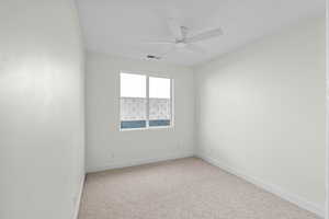 Unfurnished room featuring light carpet and ceiling fan