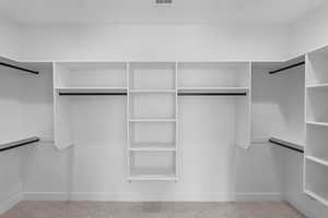 Spacious closet with carpet