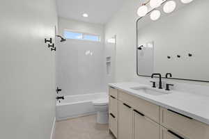 Full bathroom featuring vanity, shower / washtub combination, and recessed lighting