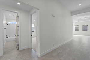 Hall featuring recessed lighting and baseboards