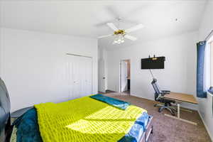 Bedroom with a closet, carpet, a ceiling fan, and a desk