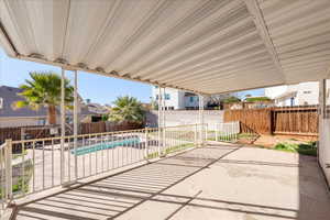 Fenced backyard with a patio and a residential view