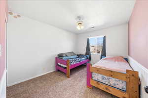 Carpeted bedroom featuring baseboards