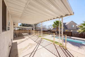 Fenced backyard with a patio area