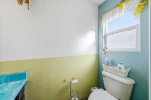 Half bathroom with vanity and toilet