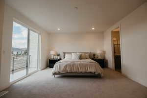 Bedroom with access to outside, carpet floors, ensuite bath, and recessed lighting