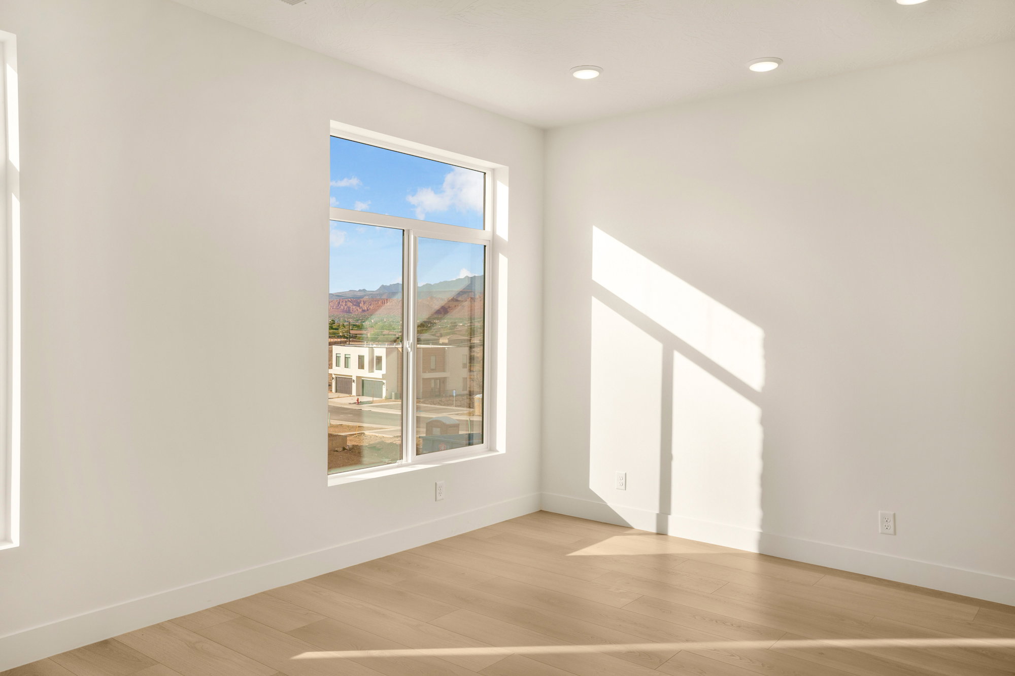 Room featuring light wood-finish flooring, white baseboards, and recessed ceiling lighting