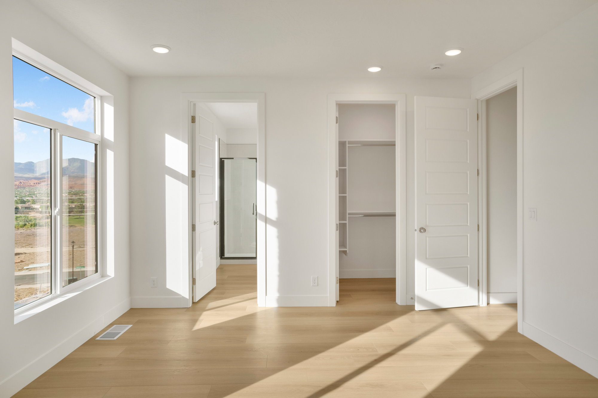 Bright interior featuring wood-finish flooring and recessed lighting