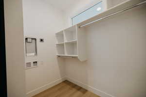 Washroom featuring light wood finished floors and washer hookup