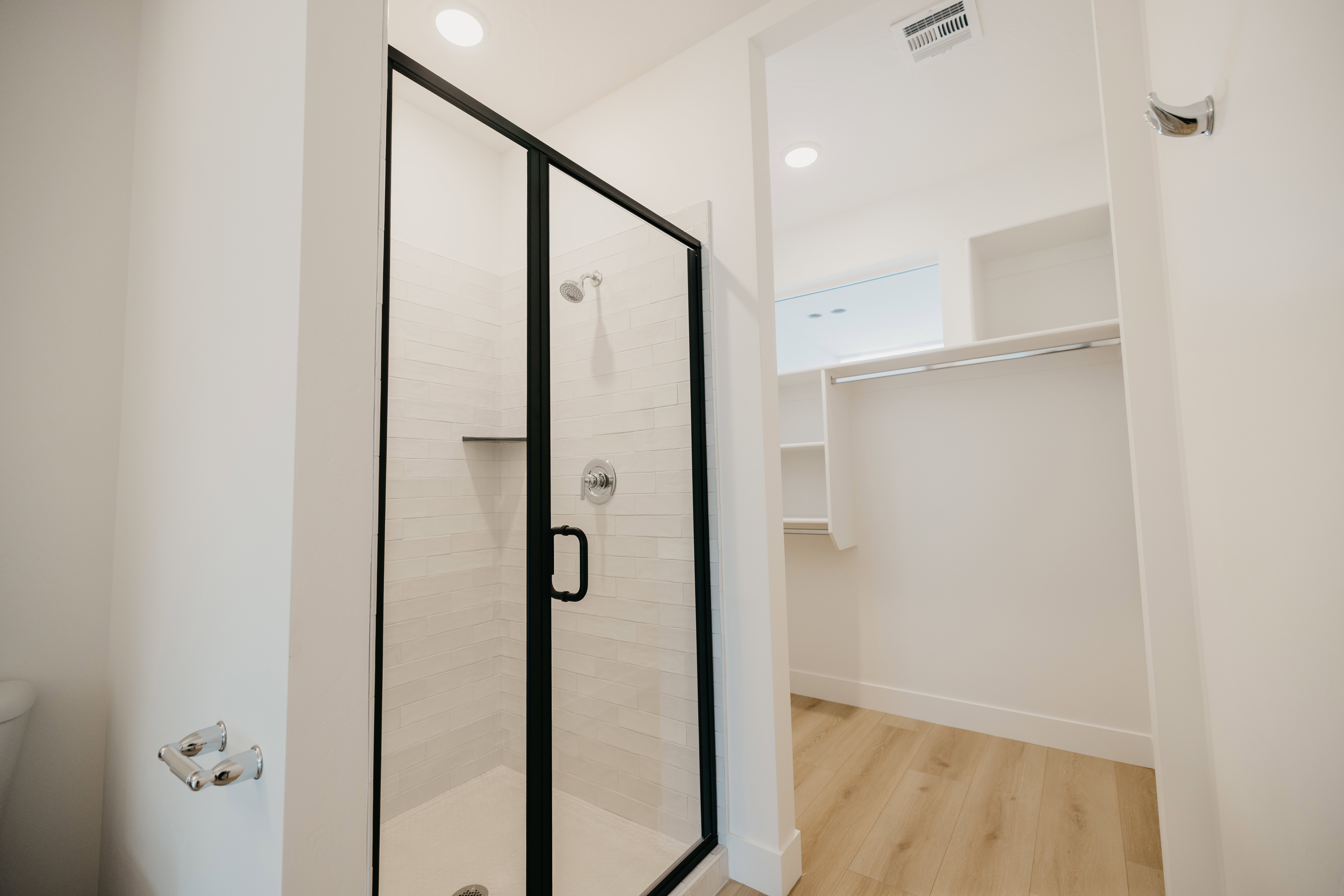 Full bathroom with a stall shower, light wood finished floors, a walk in closet, and recessed lighting