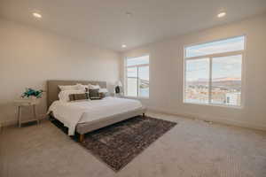 Carpeted bedroom featuring recessed lighting and a mountain view