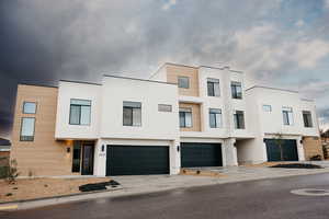 Contemporary home featuring stucco siding, concrete driveway, and an attached garage