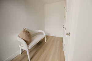 Sitting room with baseboards and light wood-type flooring