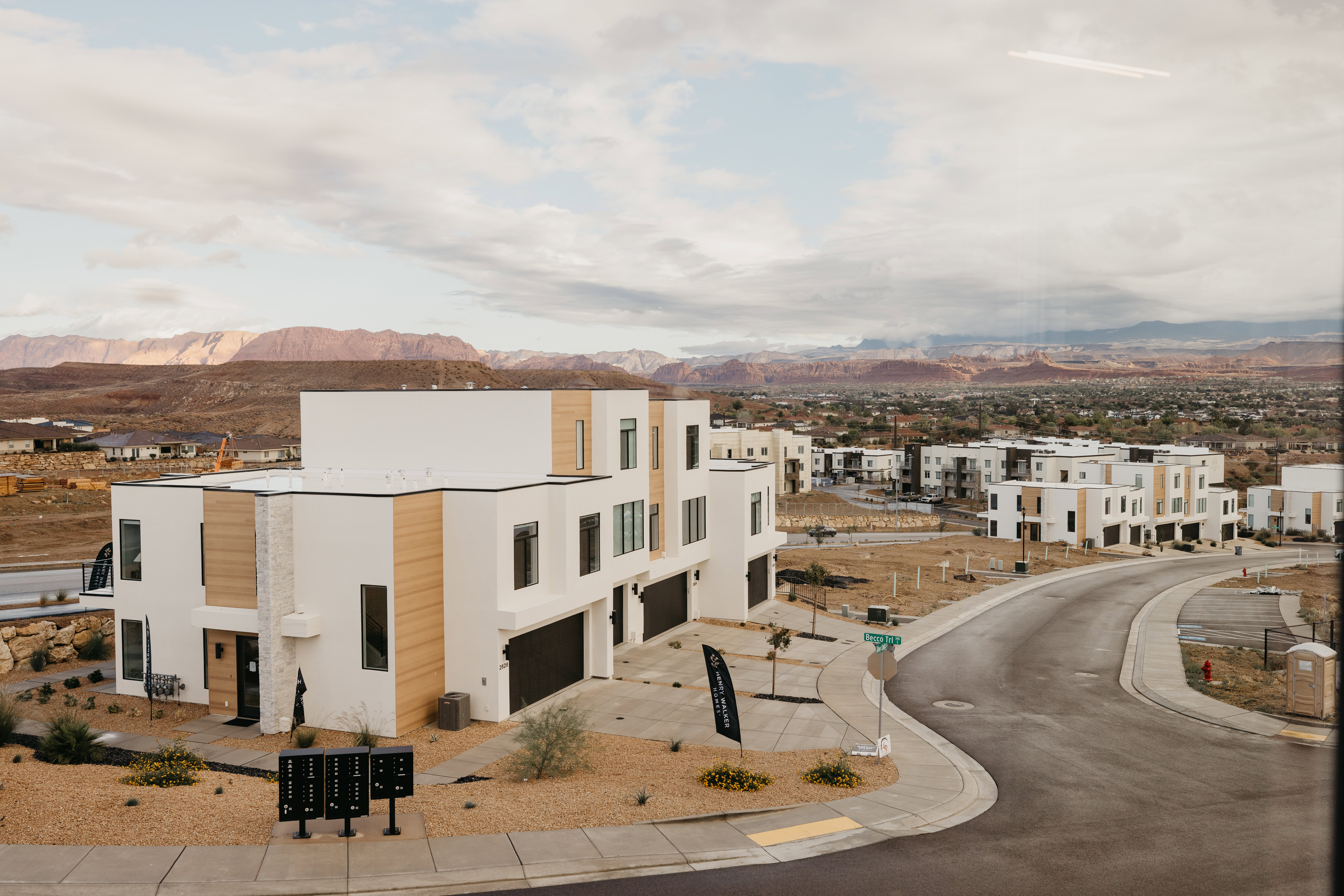View of property featuring driveway, an attached garage, a mountain view, and a residential view