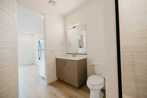 Bathroom featuring vanity and light wood-style floors