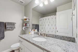 Full bathroom with vanity and a shower with shower curtain